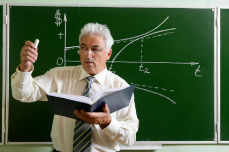 white-haired speckled man with book open, teaching math, equation on board behind