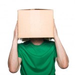 man in green shirt with box over his head