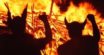 Anglo-Saxon-Jutes silhouetted against burning Celtic village