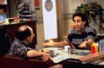 Jerry Seinfeld sitting across a table from George Costanza 